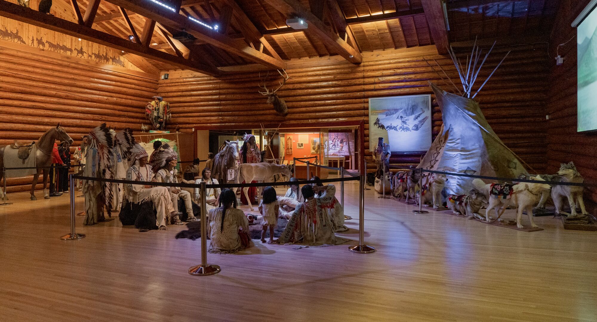 An interior of the displays at the Buffalo Nations Museum in Banff showing traditional clothing and a teepee. 