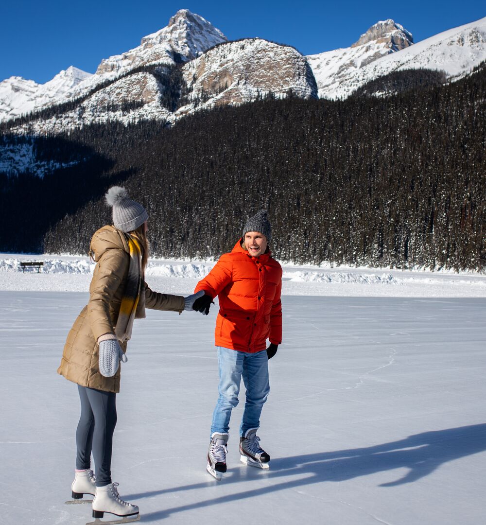 A couple skating on Lake Louise in the winter in Banff National Park