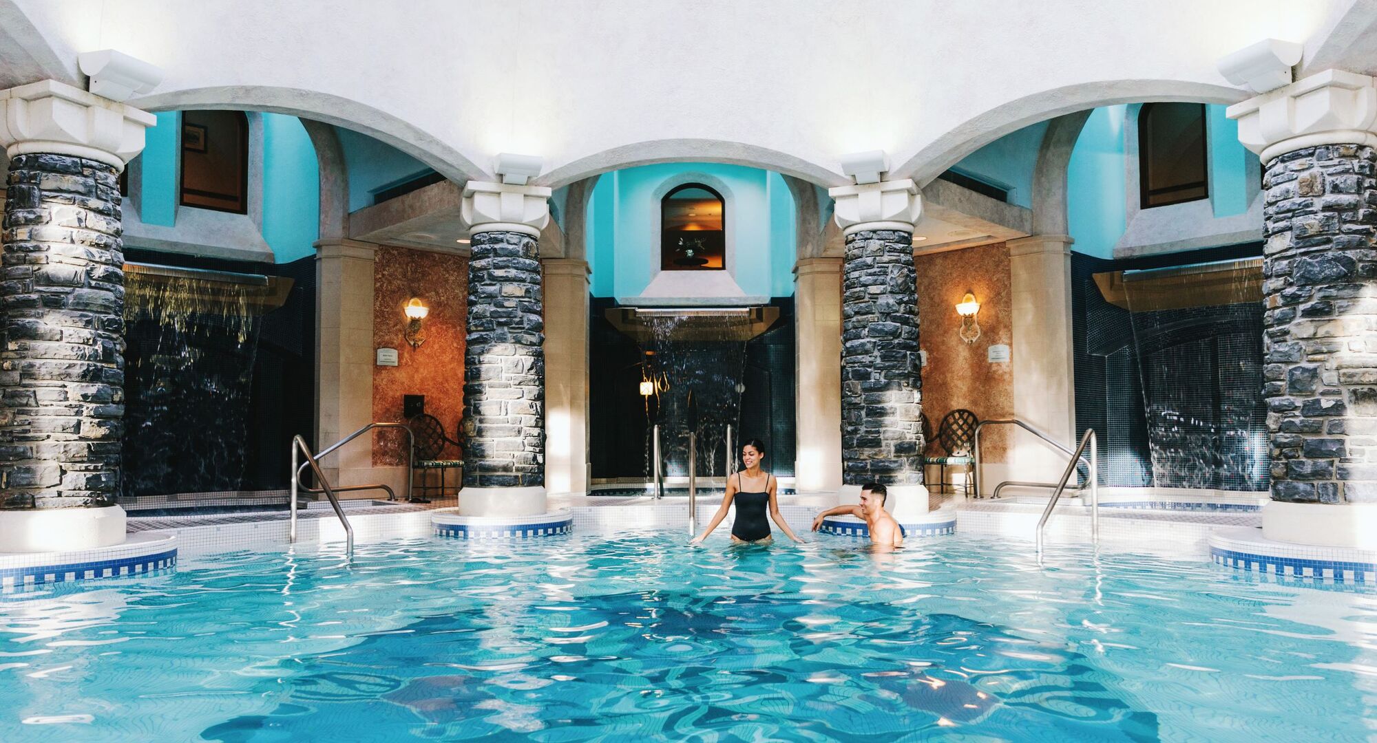 Two people in a pool at Willow Stream Spa at the Fairmont Banff Springs