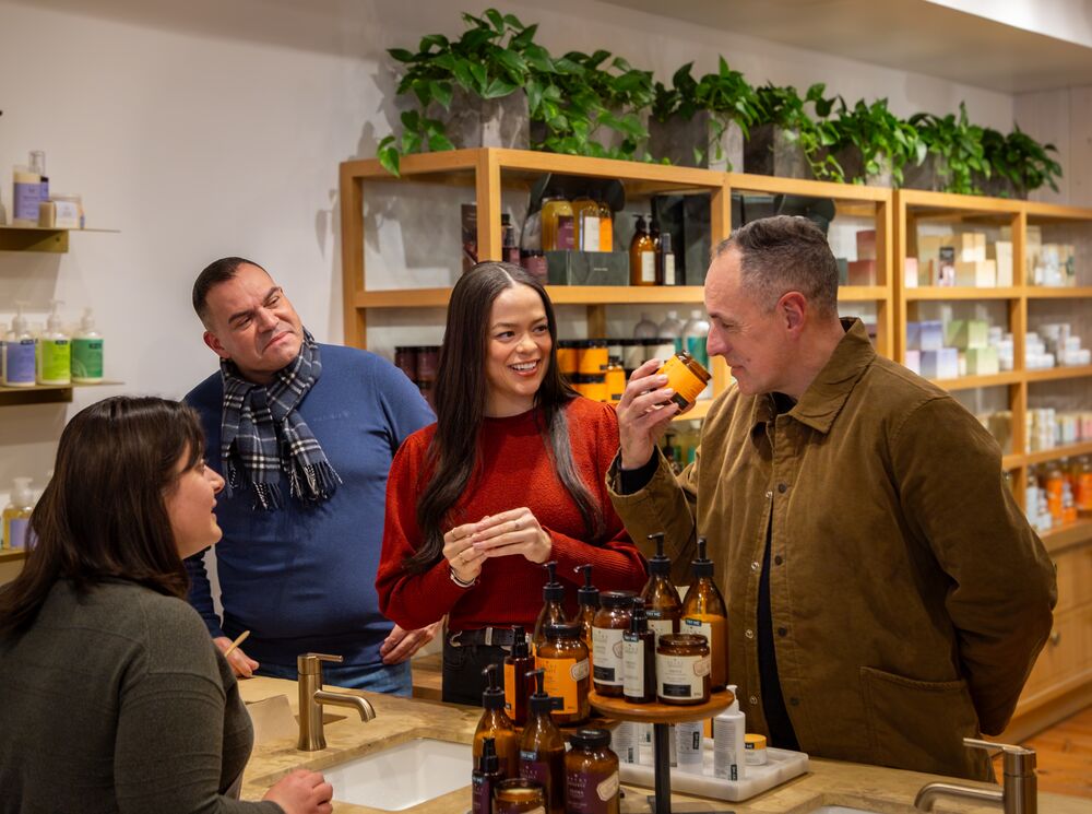 Friends smelling and trying products at Rocky Mountain Soap Company in Banff.