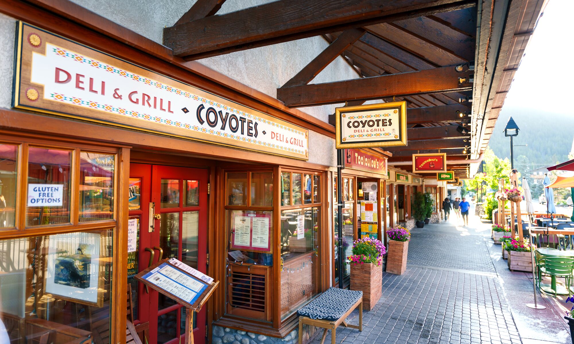 Caribou Street in Banff, featuring the Coyotes Southwestern Grill storefront, in the summer in Banff, Canada.