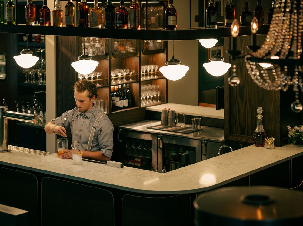 A bartender prepares drinks at Brazen, a restaurant located on Banff Ave in Banff National Park