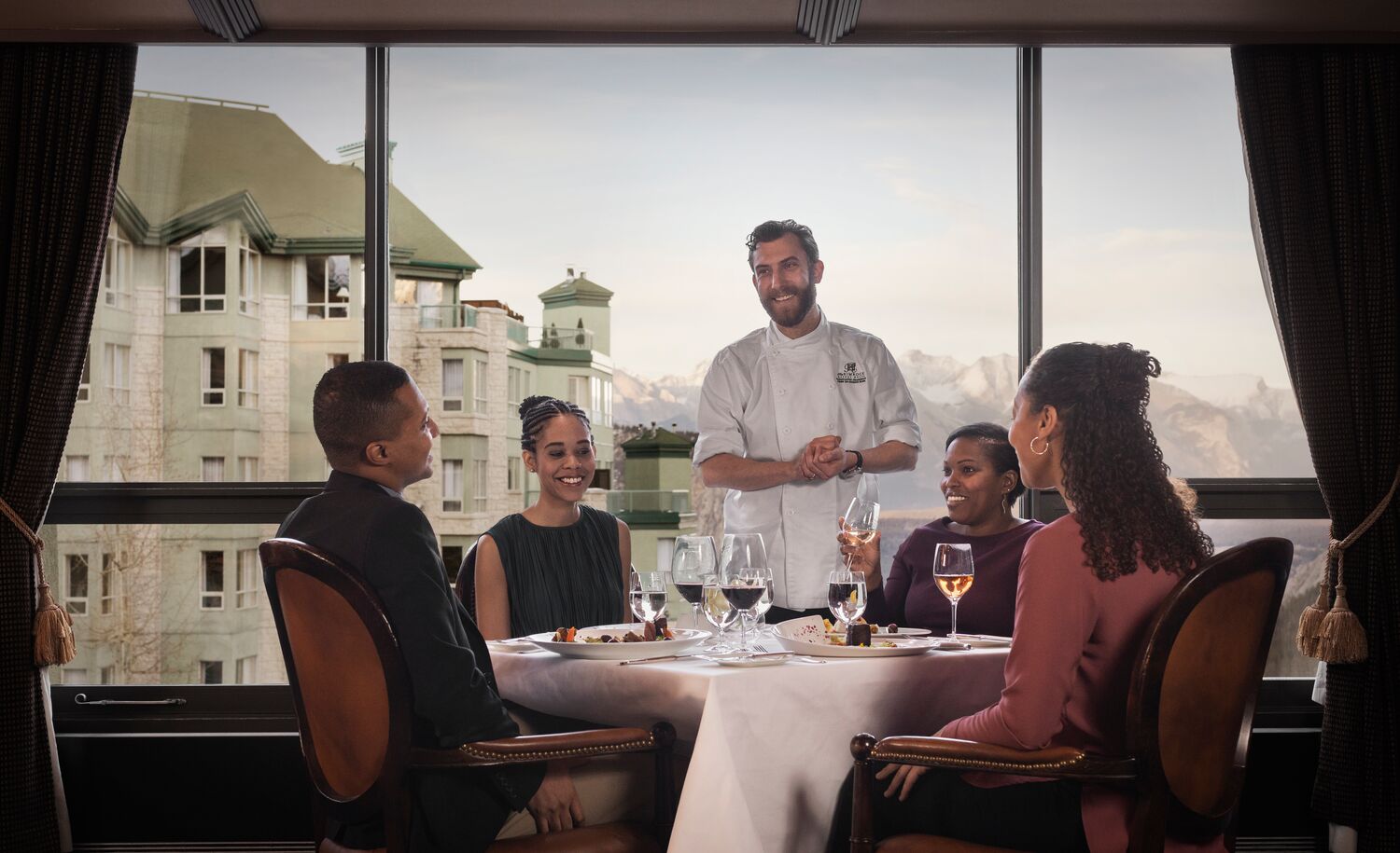 A chef talks to a table of people at Eden in Banff National Park.