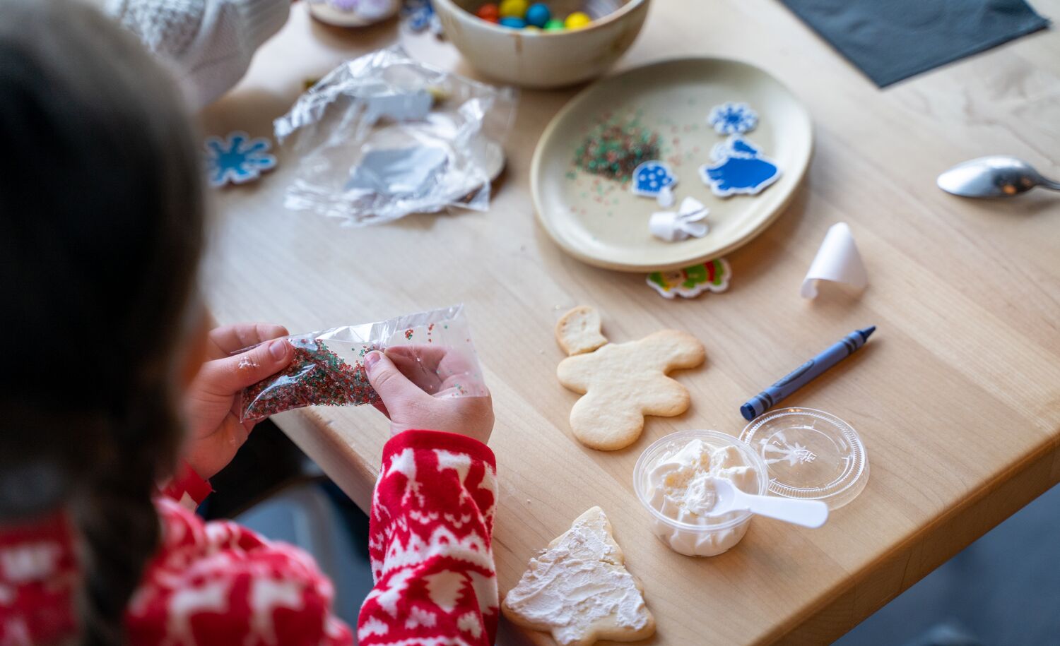 A child makes a Christmas cookie at Mountaintop Christmas in Banff National Park at the Banff Gondola.