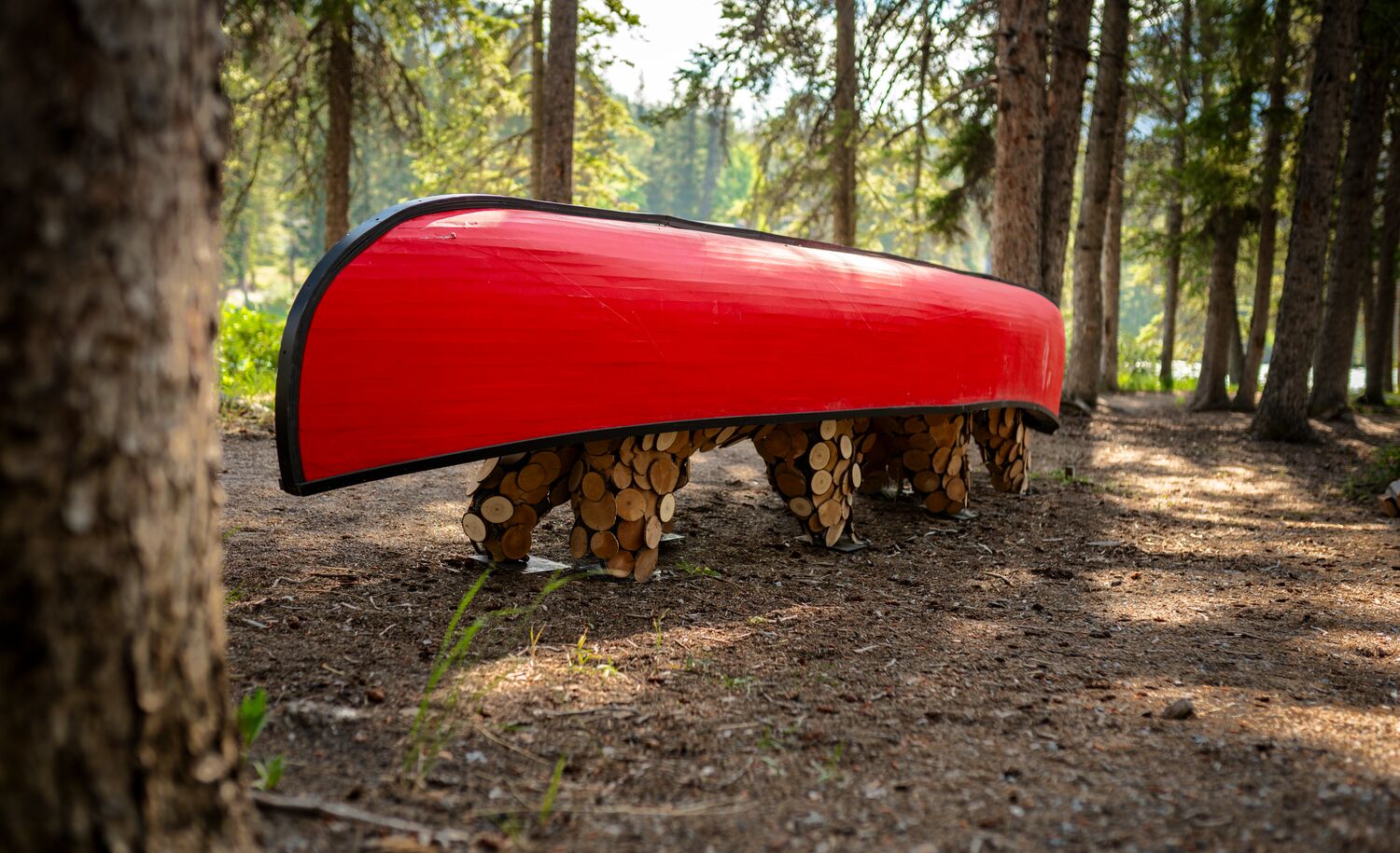 An art piece of a canoe on the back of two bears on the Art in Nature Trail in Banff National Park.