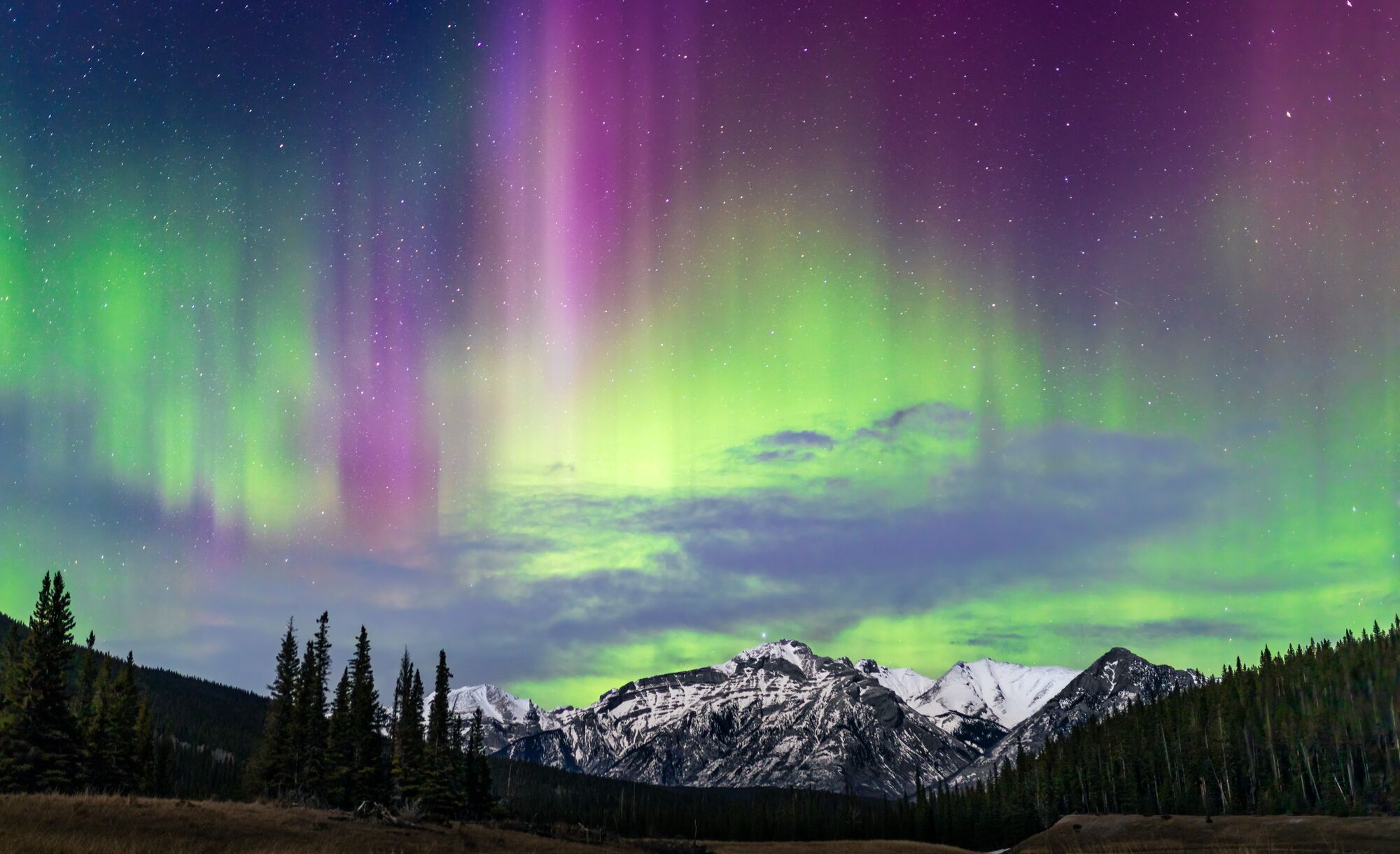 Northern lights over a mountain on the Minnewanka Loop in Banff National Park.