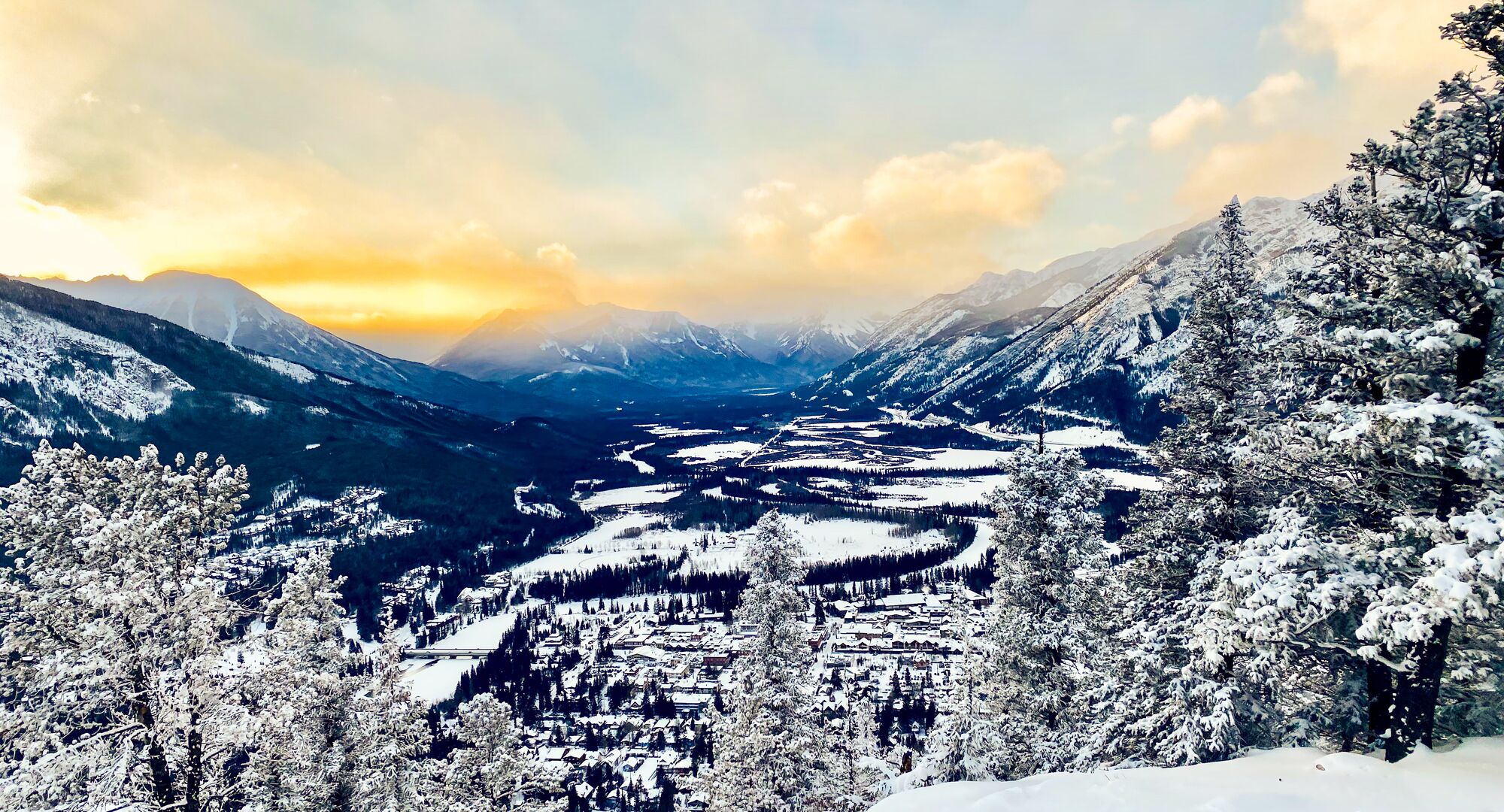 View looking out across a snow covered town of Banff from the top of Tunnel Mountain in the winter.