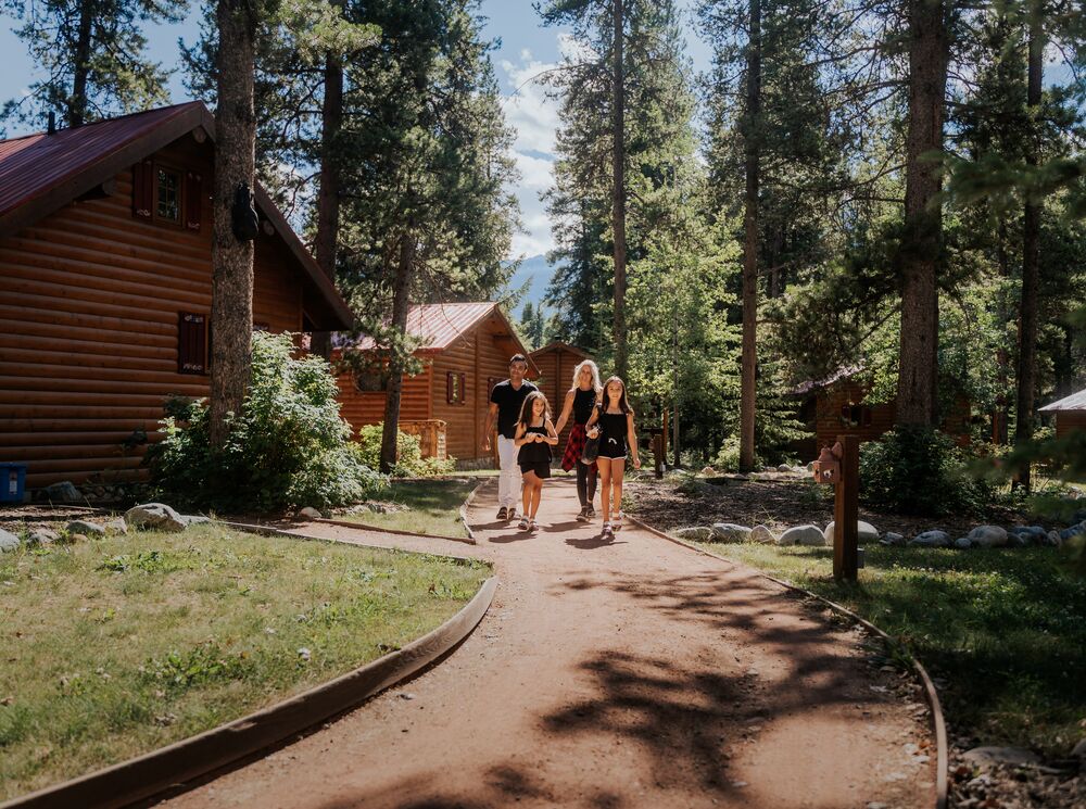 A family walks a path at Baker Creek Mountain Resort by Basecamp.