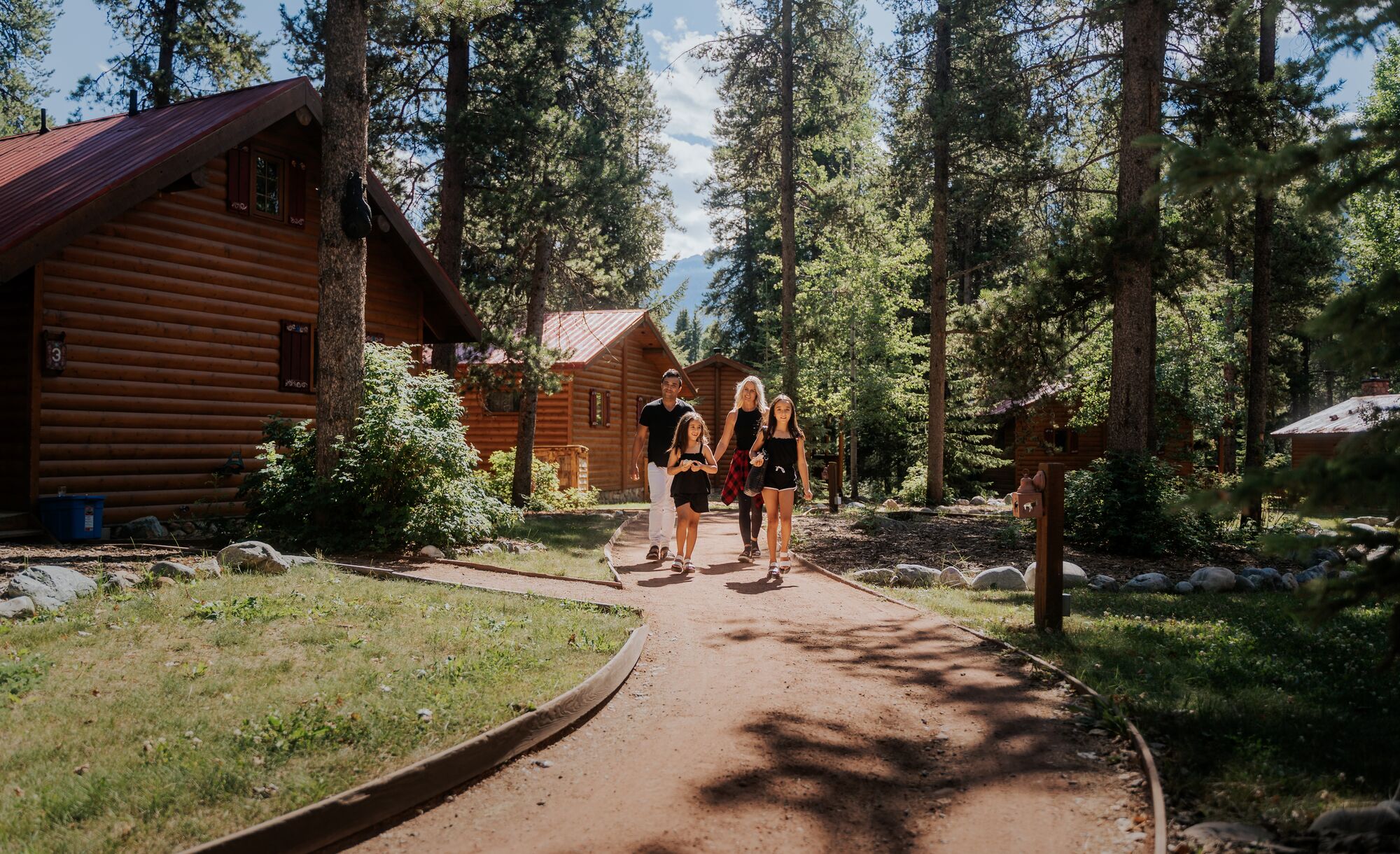 A family walks a path at Baker Creek Mountain Resort by Basecamp.