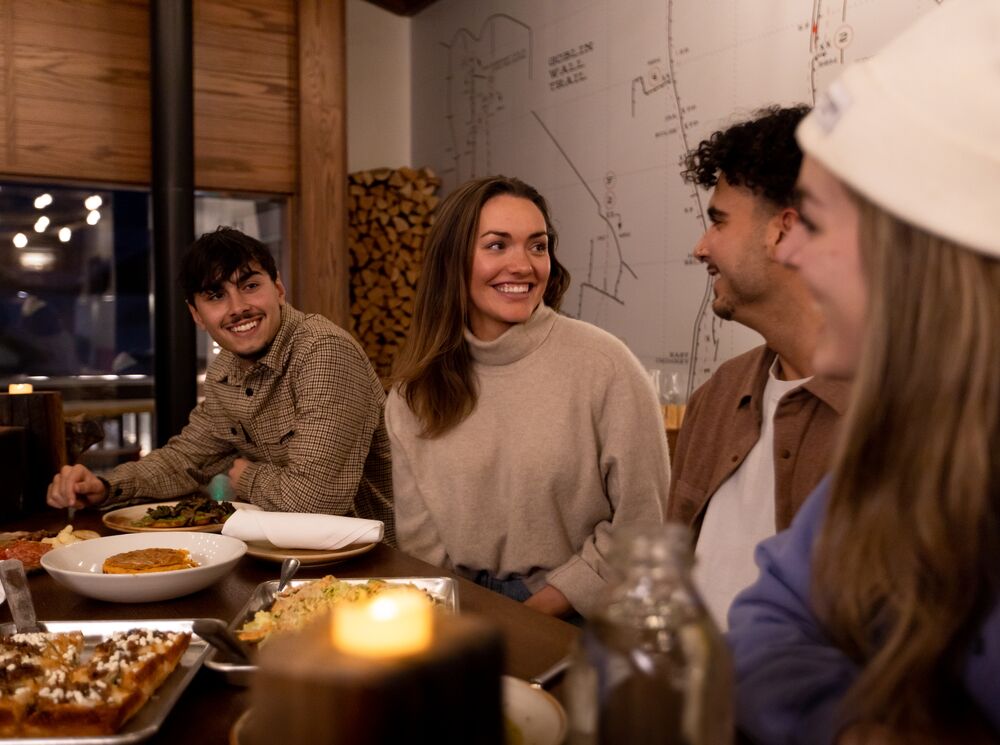 Friends eating food and enjoying après at Banff Ave Brewing Co.