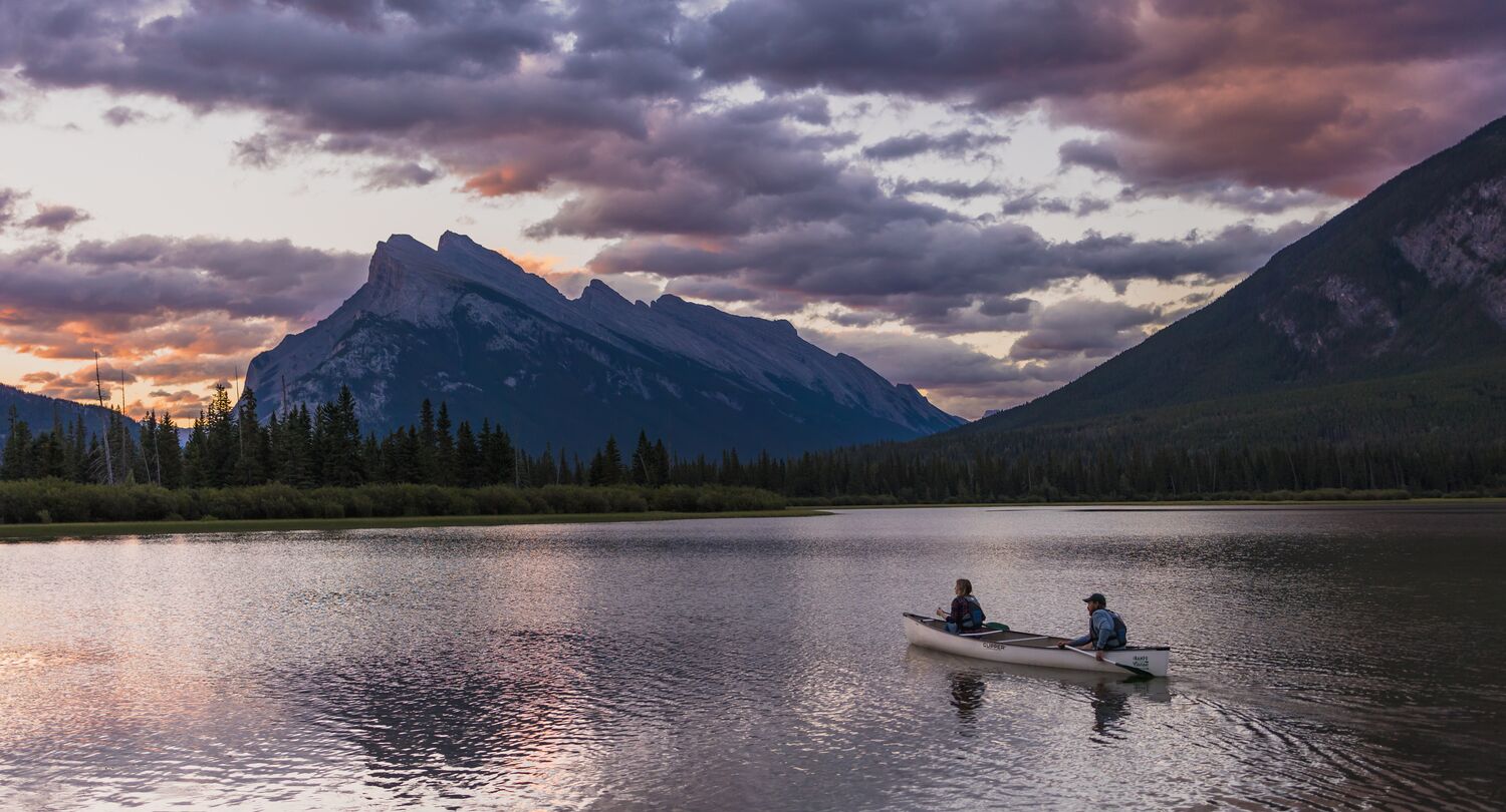 Banff Canoe Club canoeing at sunrise or sunset on Vermilion Lakes near Banff Town