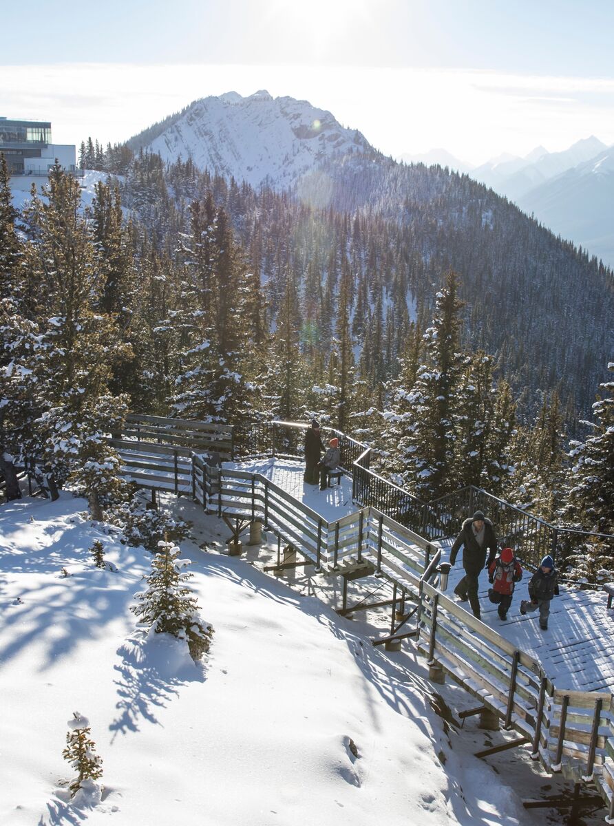 A family walks along the boardwalk on top of Sulphur Mountain at the Banff Gondola in Banff National Park.