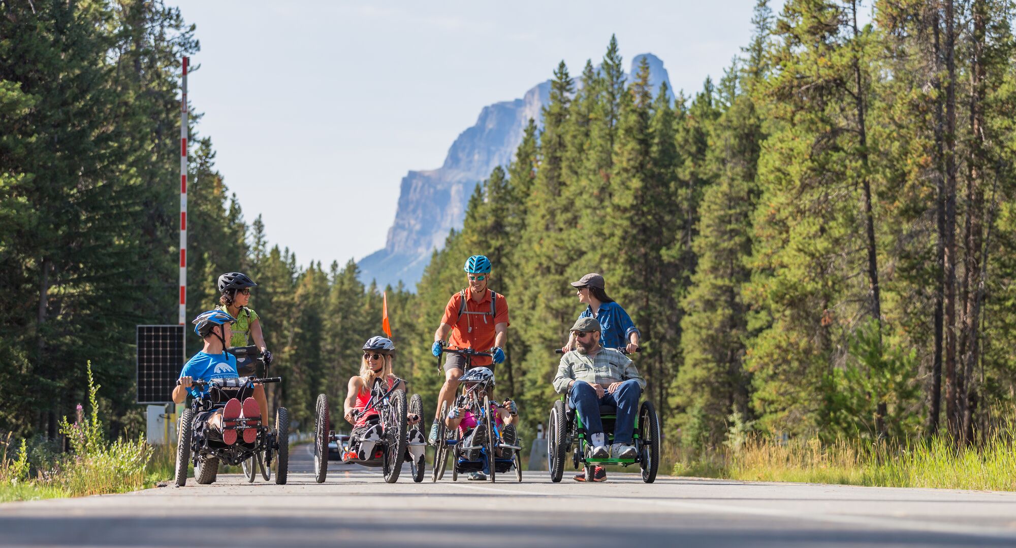 A group of people exploring the Bow Valley Parkway by bike and wheelchair