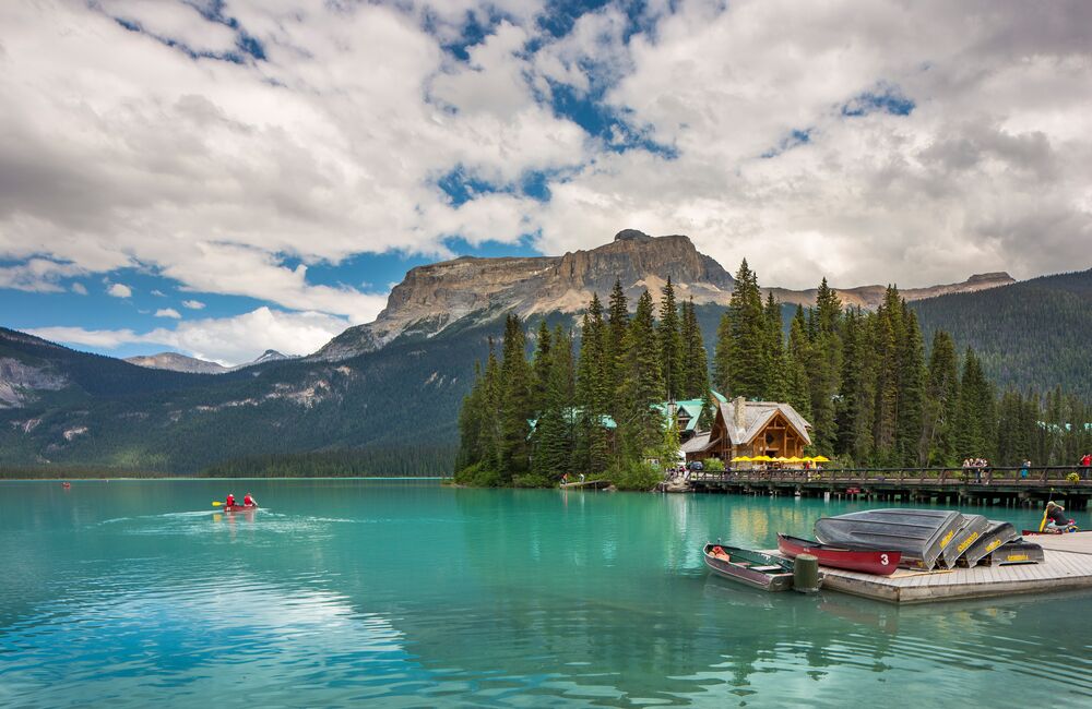The turquoise waters of Emerald Lake glisten in the sunshine on a summer day