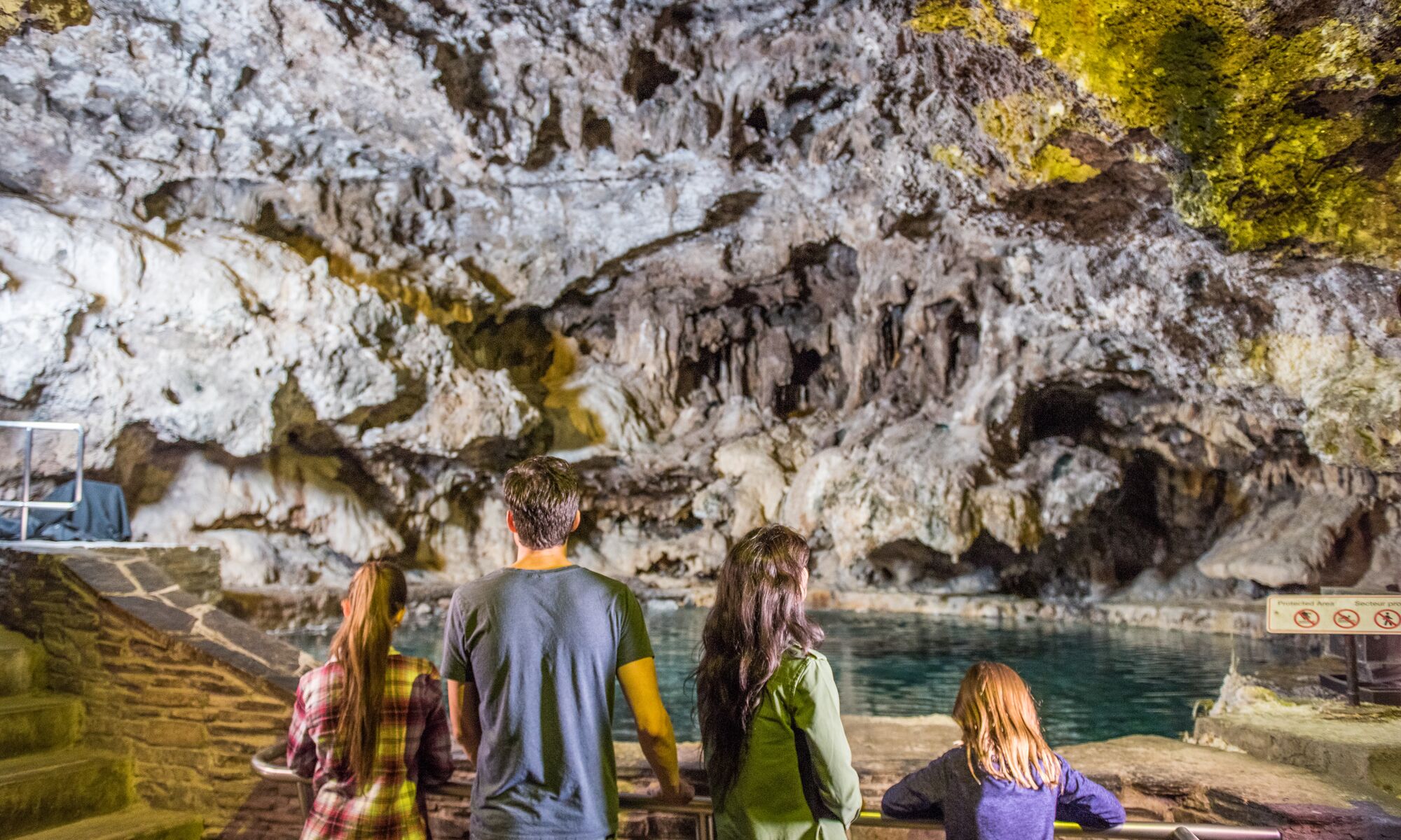 A family is inside the basin at the Cave and Basin National Historic Site in Banff National Park.