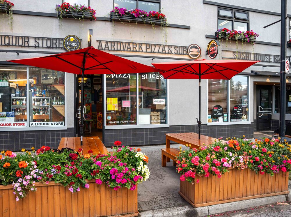 An exterior image of Aardvarks Pizza's summer patio in Banff National Park