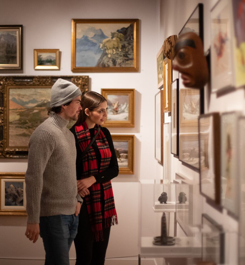 A couple taking in an art exhibit at the Whyte Museum of the Canadian Rockies