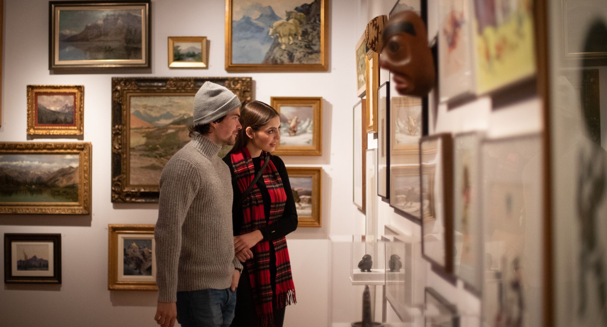 A couple taking in an art exhibit at the Whyte Museum of the Canadian Rockies