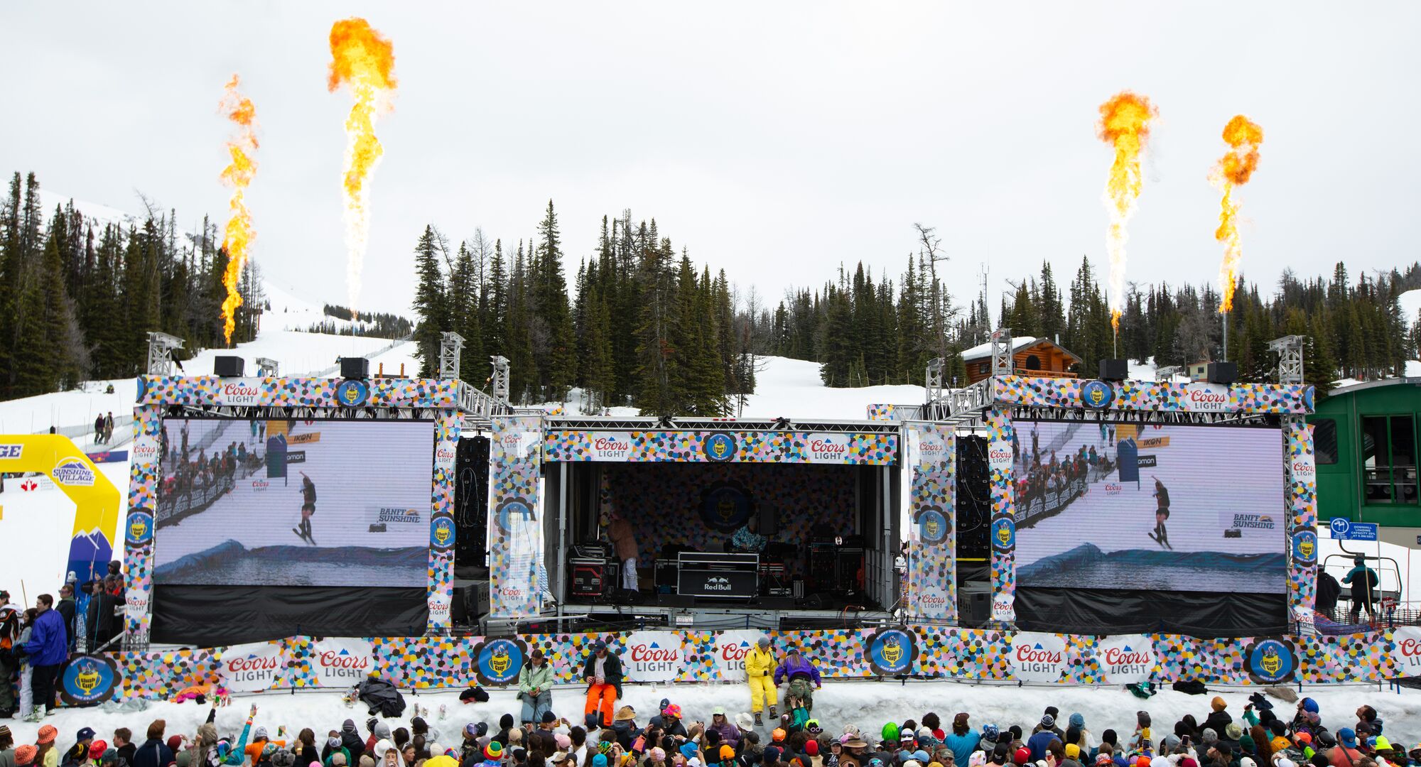 A stage with fire shooting out of it at Banff Sunshine Village during the Slush Cup celebration