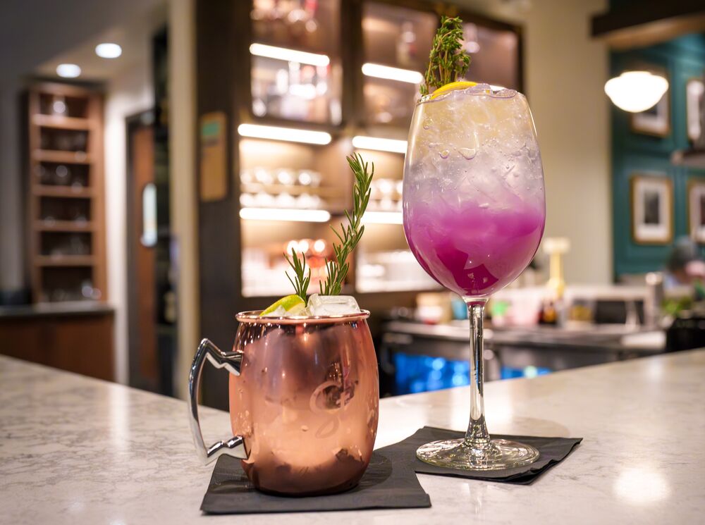 Two mocktails, perfect for zero-proof enjoyment, sit on a bar at Brazen in Banff, Canada.