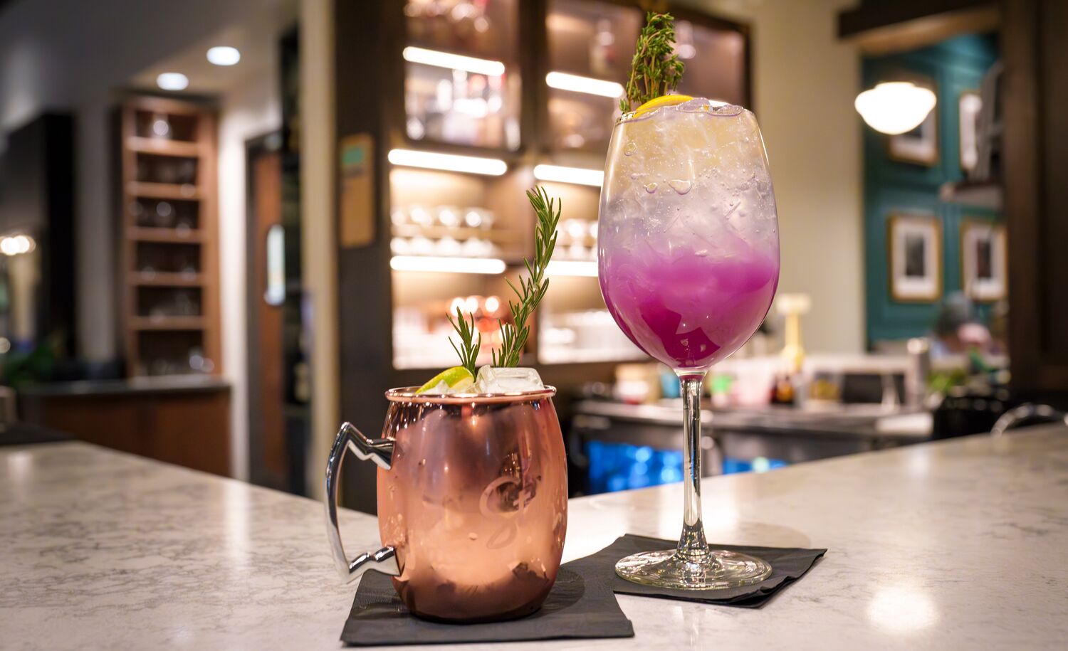 Two mocktails, perfect for zero-proof enjoyment, sit on a bar at Brazen in Banff, Canada.