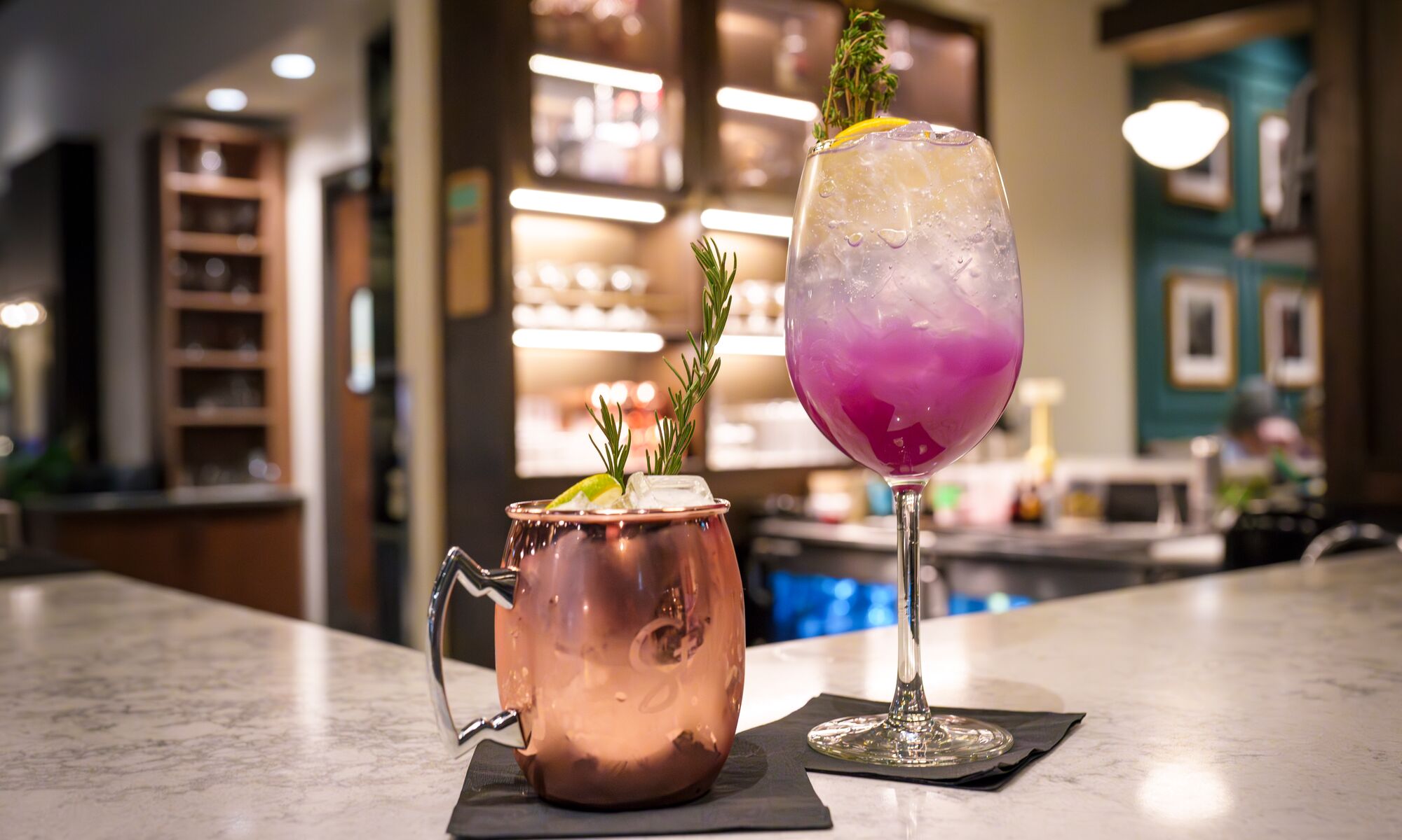 Two mocktails, perfect for zero-proof enjoyment, sit on a bar at Brazen in Banff, Canada.