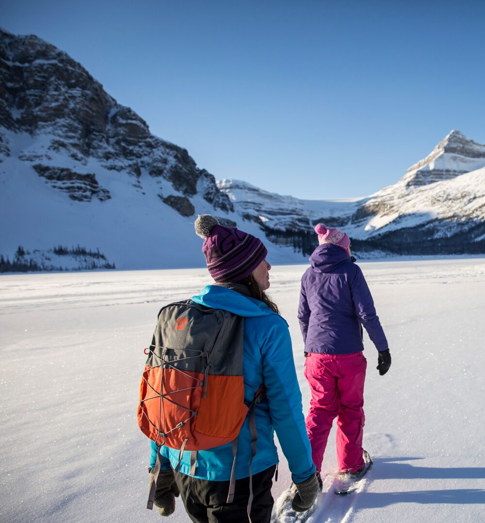 Couple snowshoeing on Bow Lake in Banff National Park