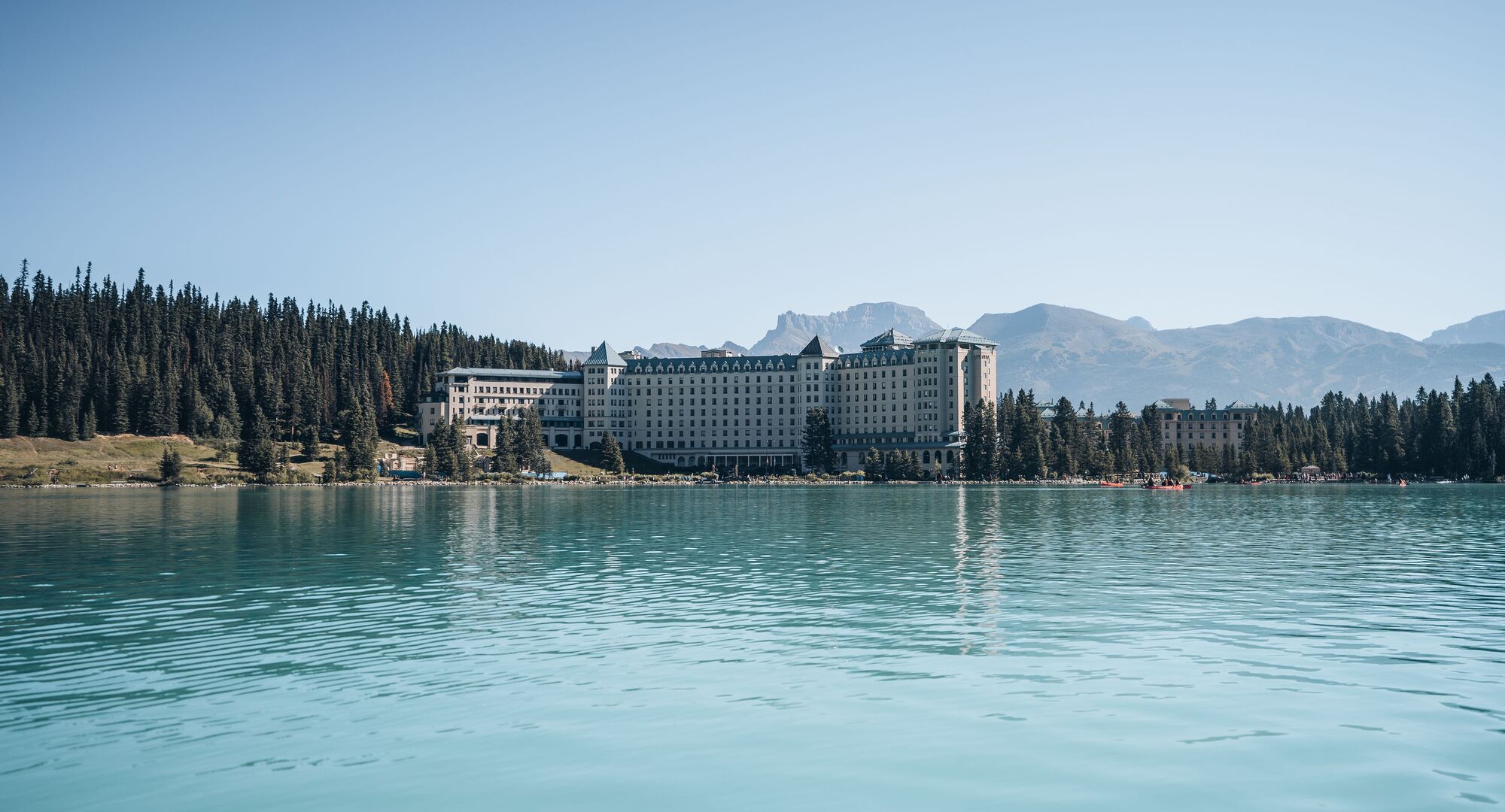 View of the Fairmont Chateau Lake Louise Hotel looking across the turquoise waters of Lake Louise