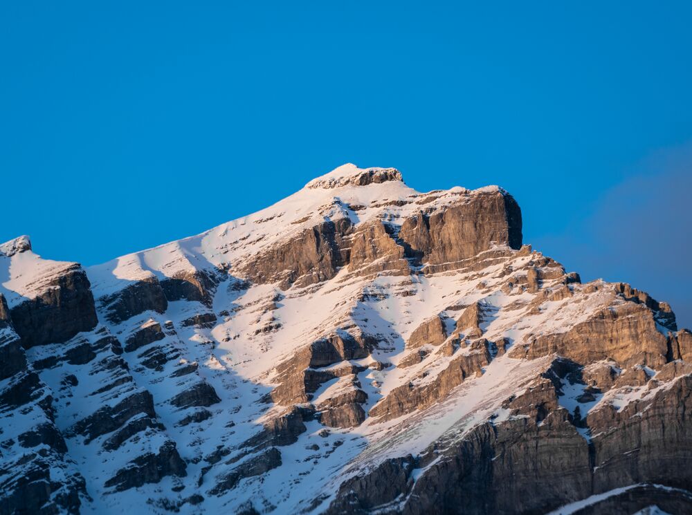 The peak of Cascade Mountain as touched by the light at sunrise in Banff National Park.
