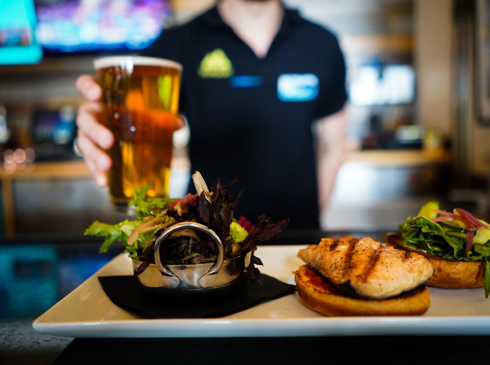 A burger and a drink being serverd at Lone Pine Lodge on Mt. Norquay in Banff National Park.