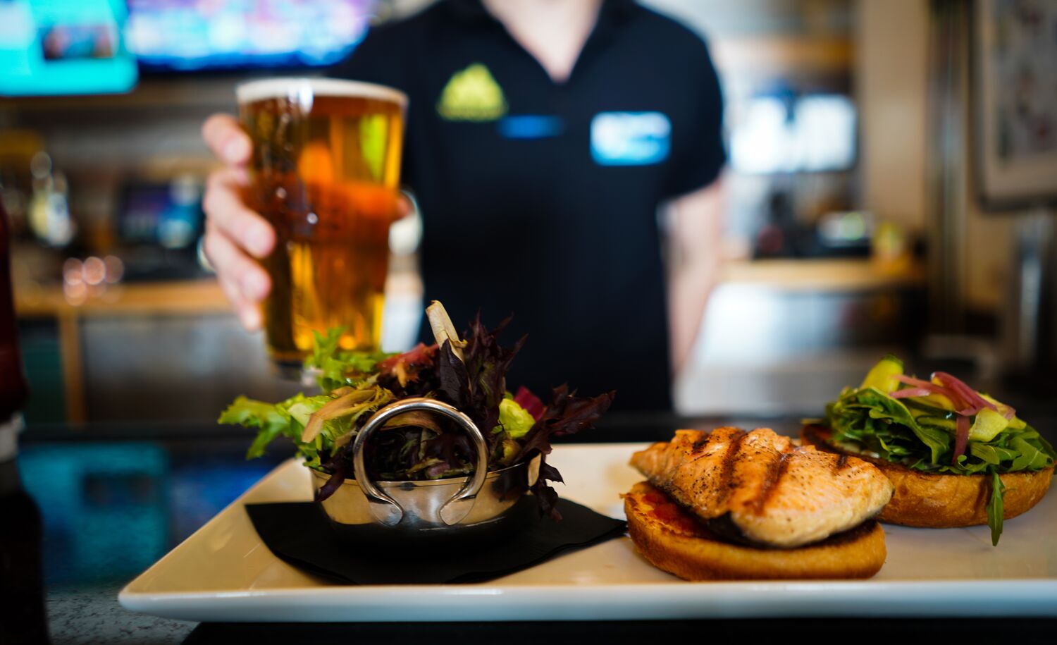 A burger and a drink being serverd at Lone Pine Lodge on Mt. Norquay in Banff National Park.