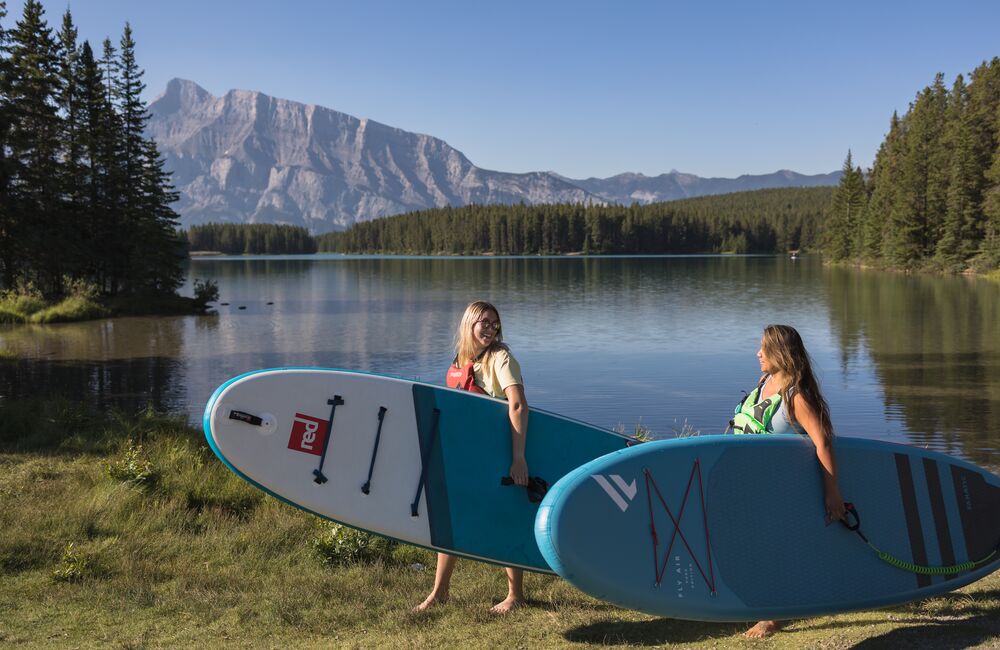 Two people taking a SUP lesson at Two Jack Lake