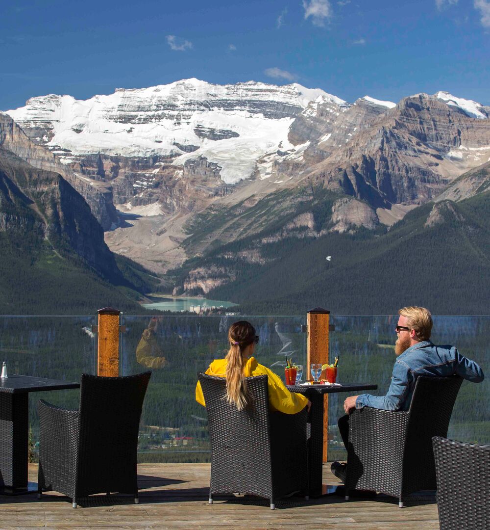 Two people taking in the view as the dine at Whitehorn Bistro at the Lake Louise Ski Resort