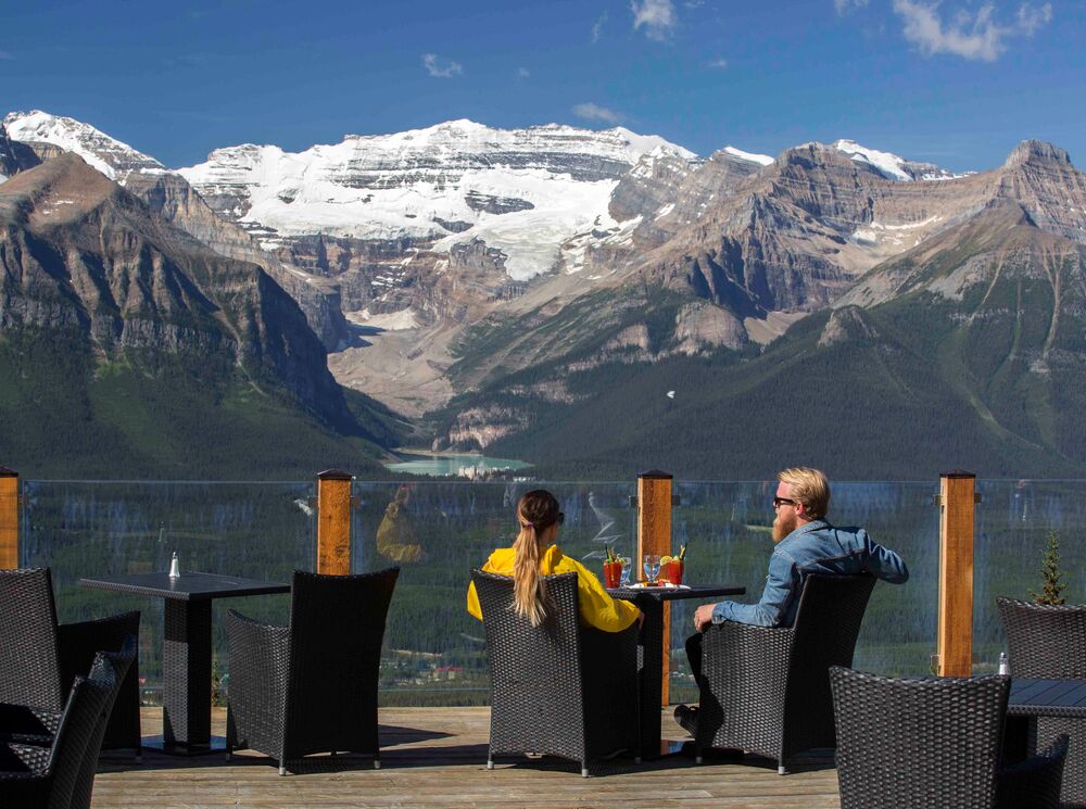 Two people taking in the view as the dine at Whitehorn Bistro at the Lake Louise Ski Resort