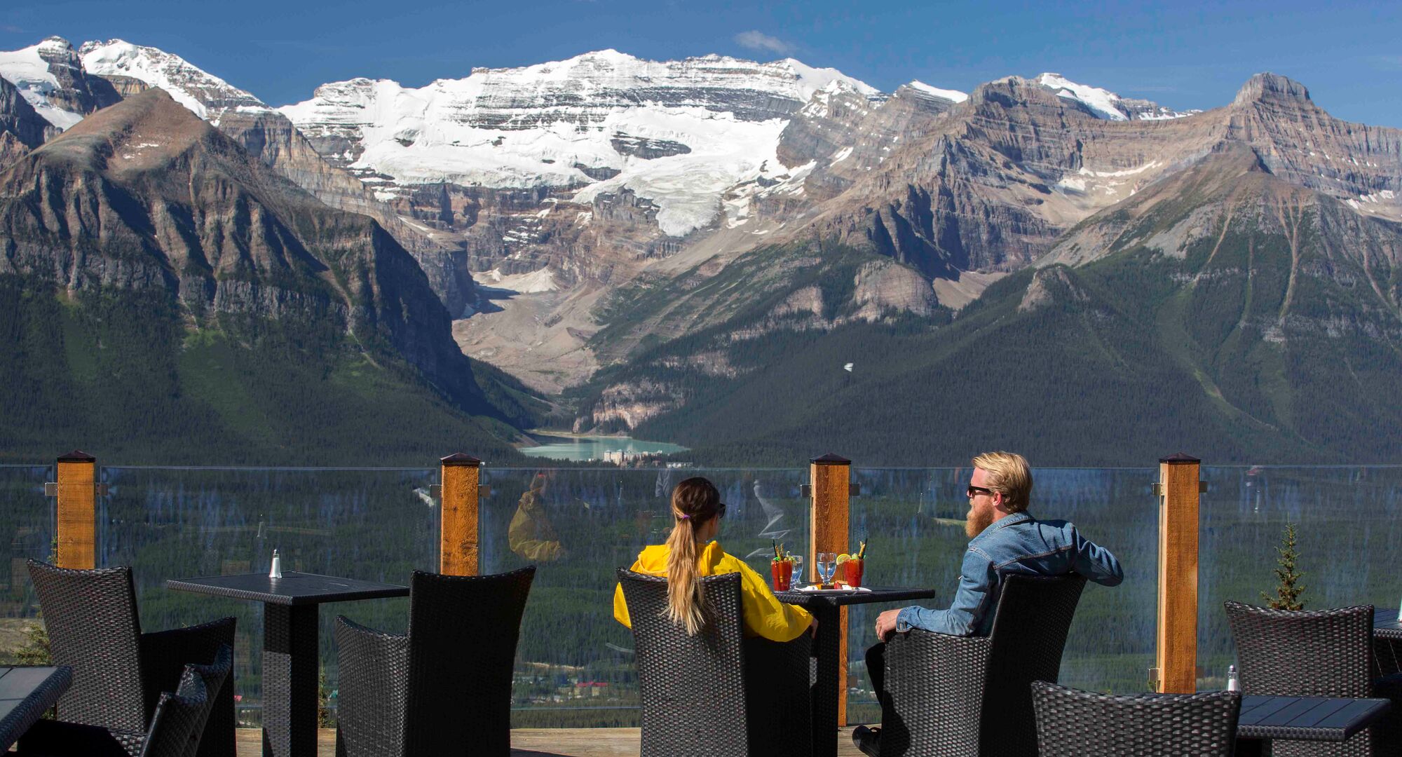 Two people on the patio at Whitehorn Bistro at the Lake Louise Summer Sightseeing Gondola