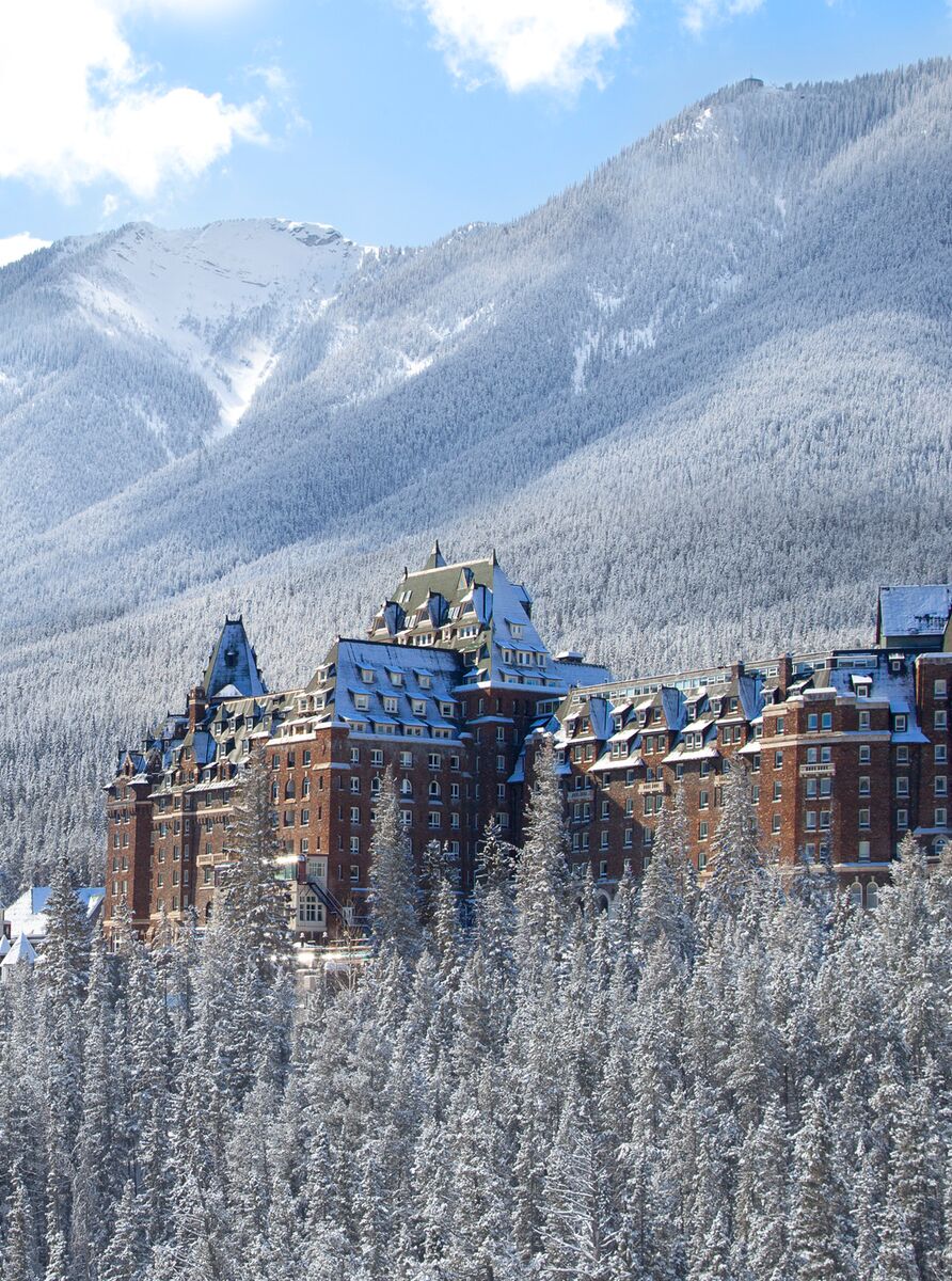 The Fairmont Banff Springs Hotel in Banff rises above frosty and snowy trees in the depths of winter in Banff National Park.