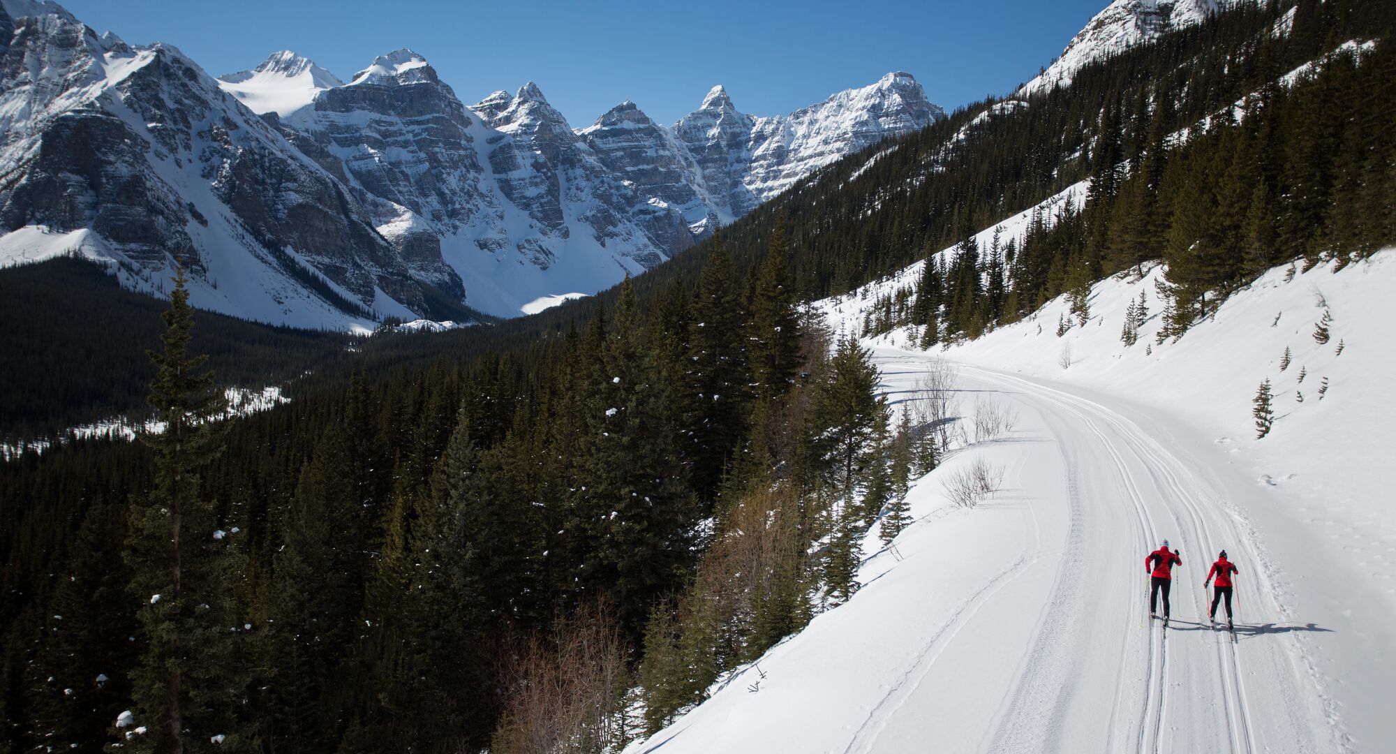 Two people skiing on Moraine Lake Road in Banff National Park