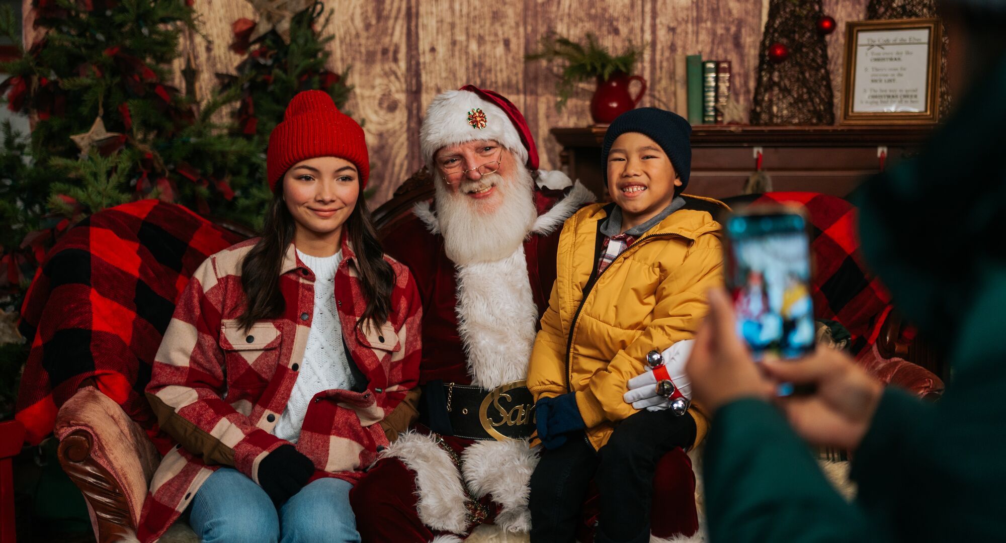Kids sit with Santa at the Banff Christmas Market.