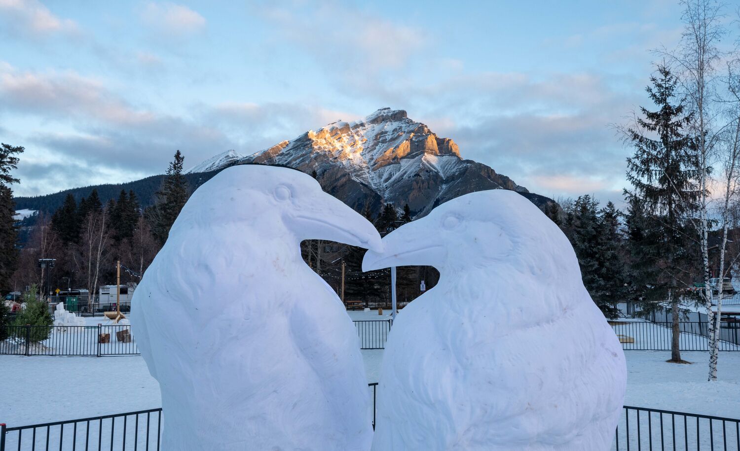 Snow sculpture of two kissing ravens in Central Park in the Banff townsite in Banff National Park