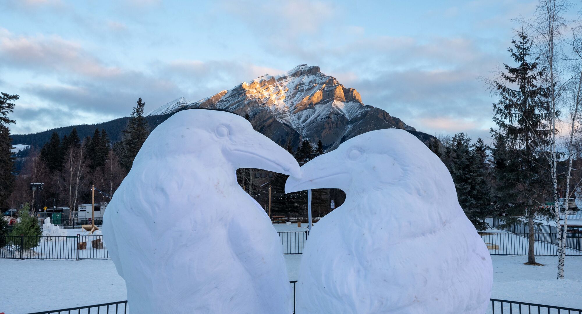 Snow sculpture of two kissing ravens in Central Park in the Banff townsite in Banff National Park
