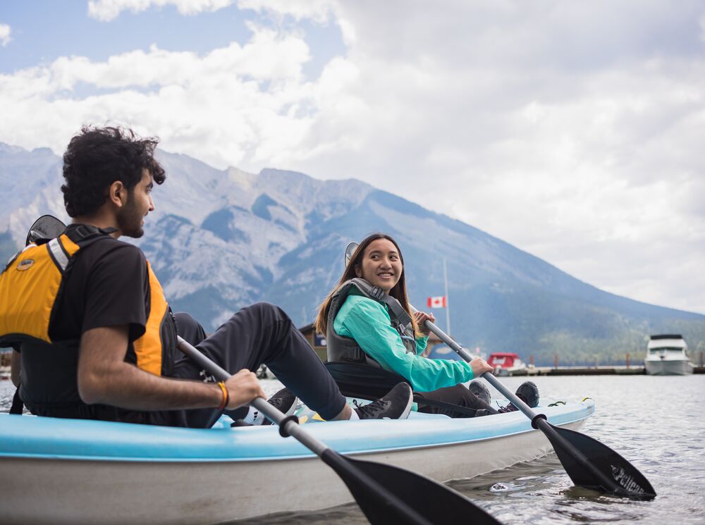 Two people in a tandem kayak in Banff National Park on Lake Minnewanka.