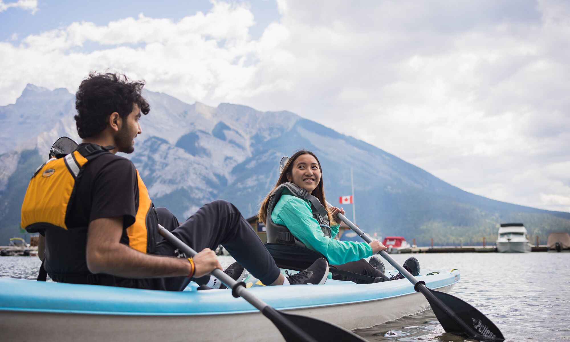 Two people in a tandem kayak in Banff National Park on Lake Minnewanka.