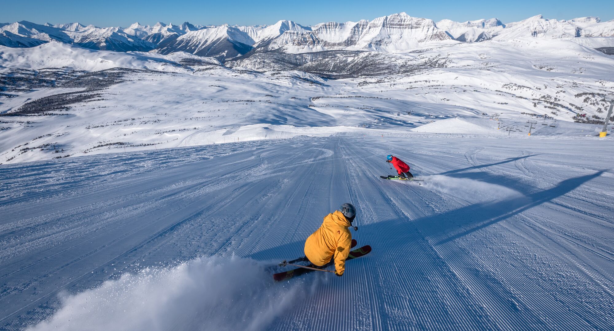 Two skiers on a run at Sunshine Village Ski Resort in Banff National Park