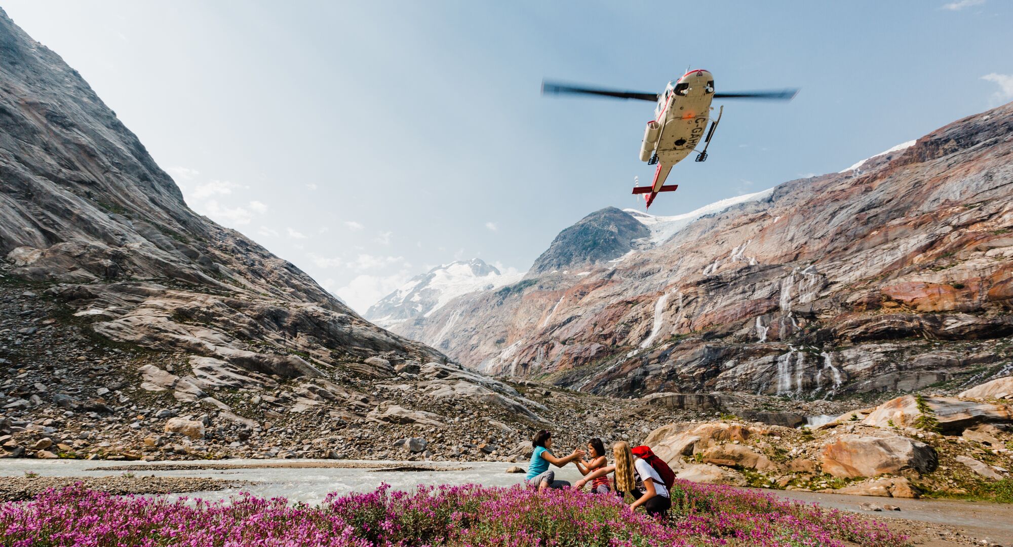 Group of people exploring a trail after being dropped off by helicopter