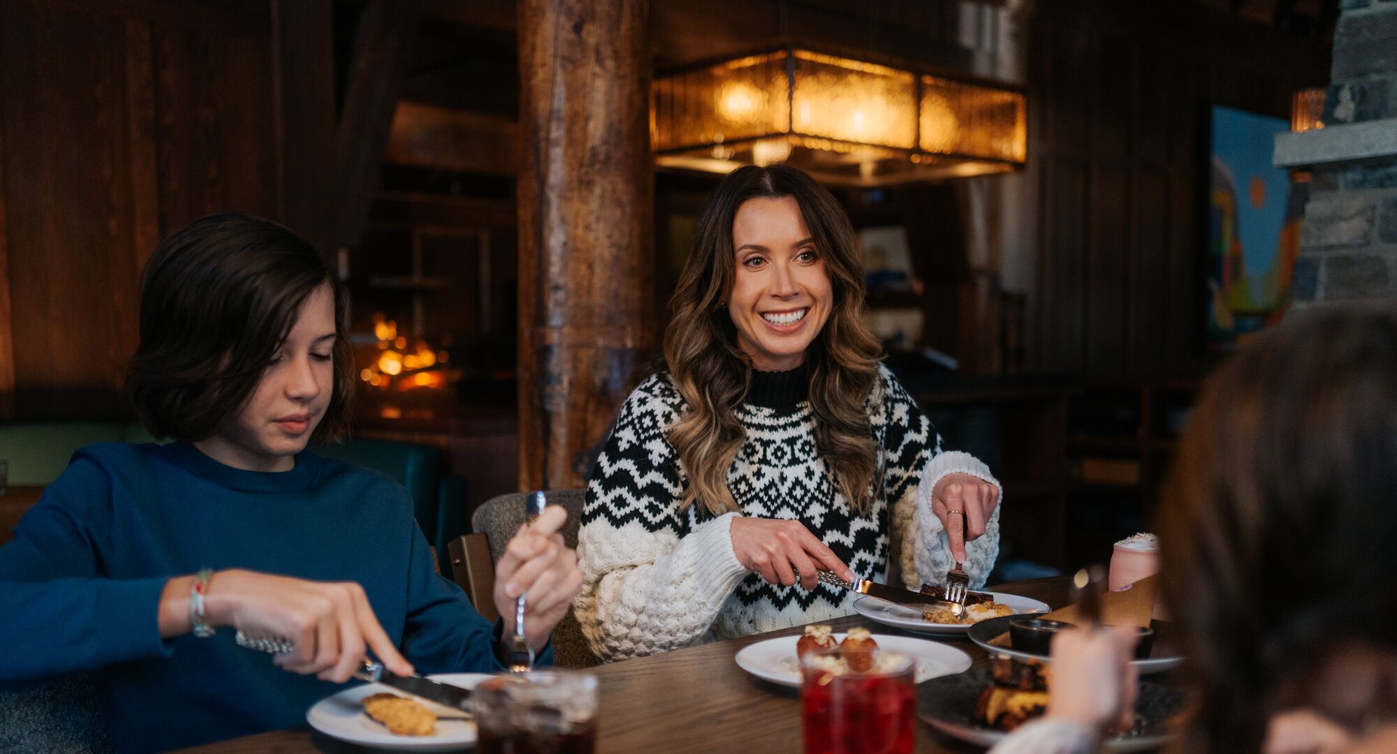Group of friends sat around a table enjoying a charcuterie board in Banff