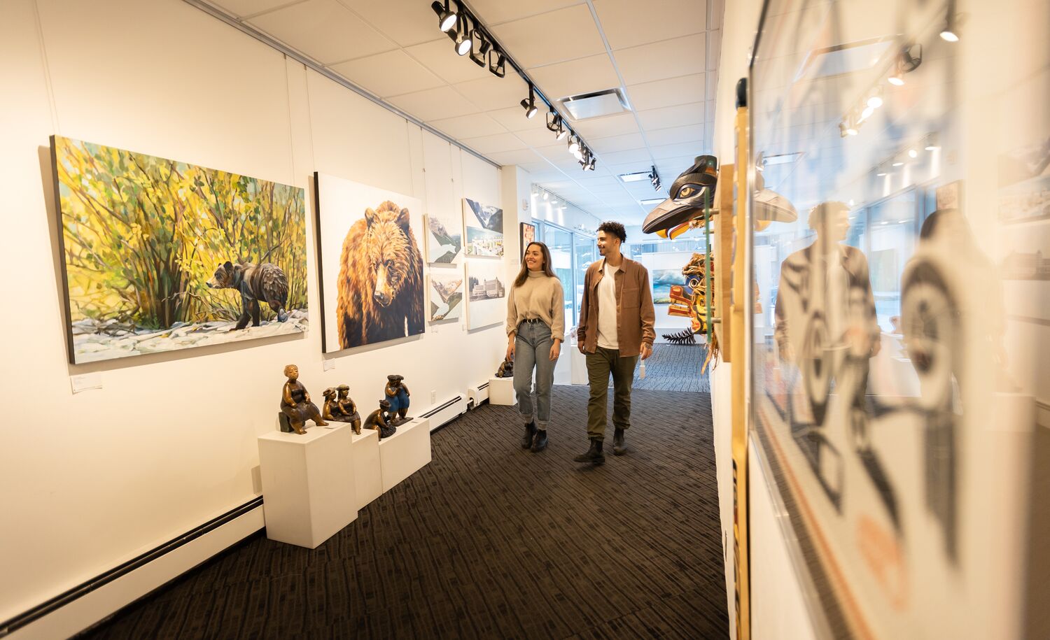 Friends explore the Canada House Gallery on Bear Street in the Banff Townsite.