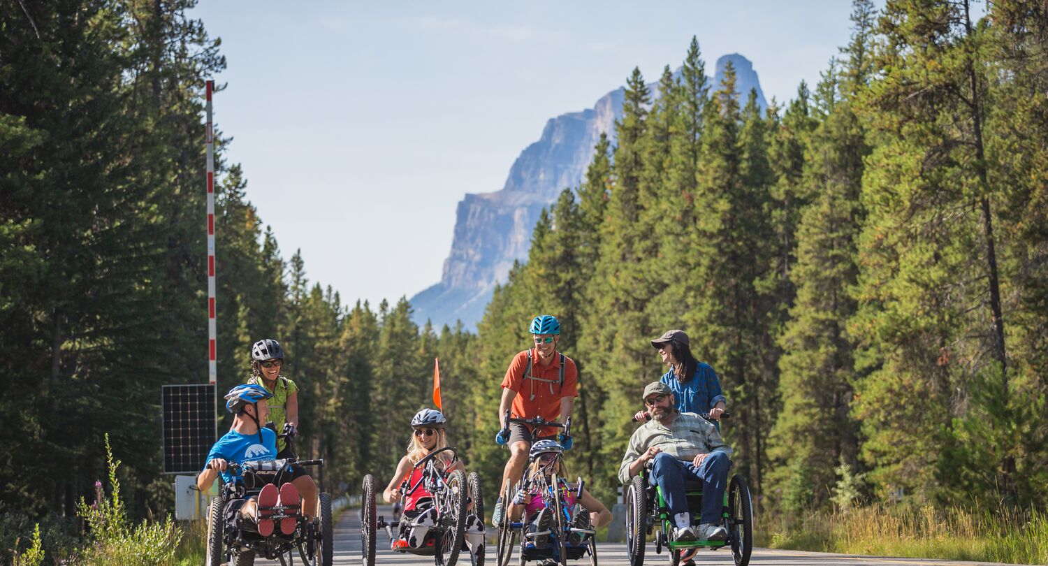 Adult group of friends cycling the Bow Valley Parkway during the summer