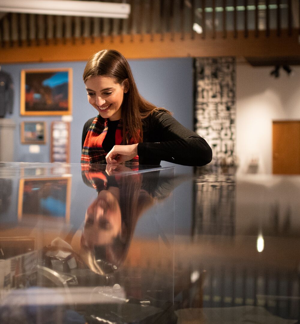 A person looking in a display case at the Whyte Museum of the Canadian Rockies