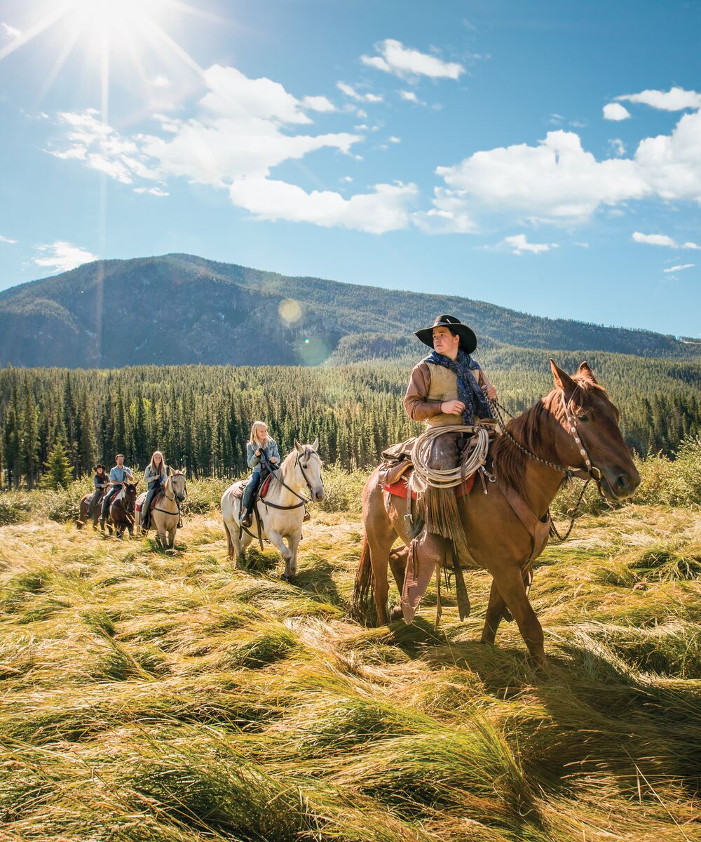 Two people riding horses in Banff National Park with Banff Trail Riders