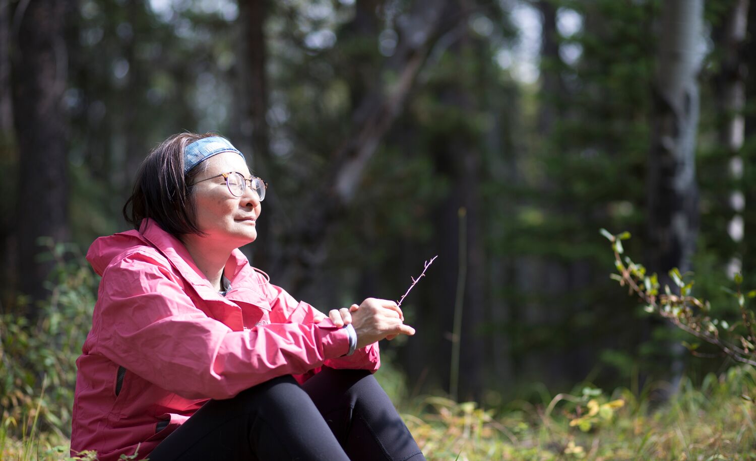 A woman participates in forest bathing with Forest Fix in Banff National Park.